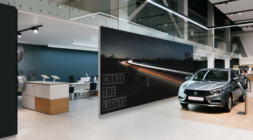  Silver sedan displayed in a modern showroom next to a 