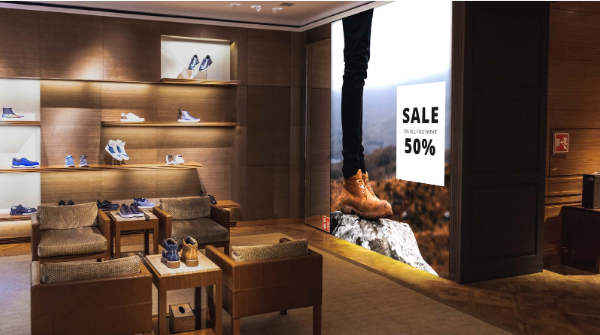 Shoe store with seating area and a 50% off footwear sale display solution.